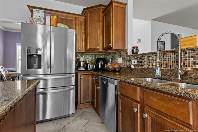 4016 Baywood Point Dr, Fayetteville, NC 28312 - kitchen with tasteful backsplash, light tile patterned floors, a sink, appliances with stainless steel finishes, and dark stone counters