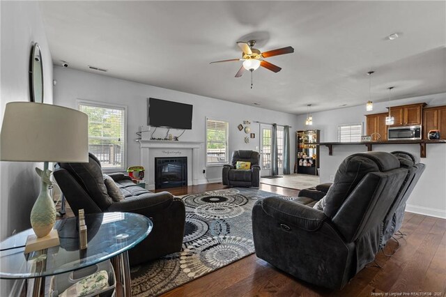 4016 Baywood Point Dr, Fayetteville, NC 28312 - living area with dark wood-type flooring, visible vents, a ceiling fan, and plenty of natural light