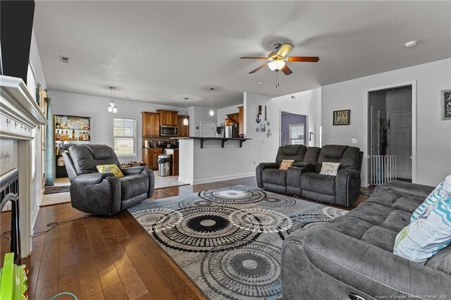 4016 Baywood Point Dr, Fayetteville, NC 28312 - living room with dark wood-type flooring, ceiling fan, baseboards, and visible vents