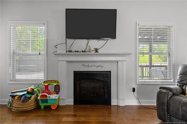 4016 Baywood Point Dr, Fayetteville, NC 28312 - living room with wood finished floors, a fireplace, and baseboards