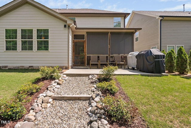 back of house with a patio area, a yard, and a sunroom