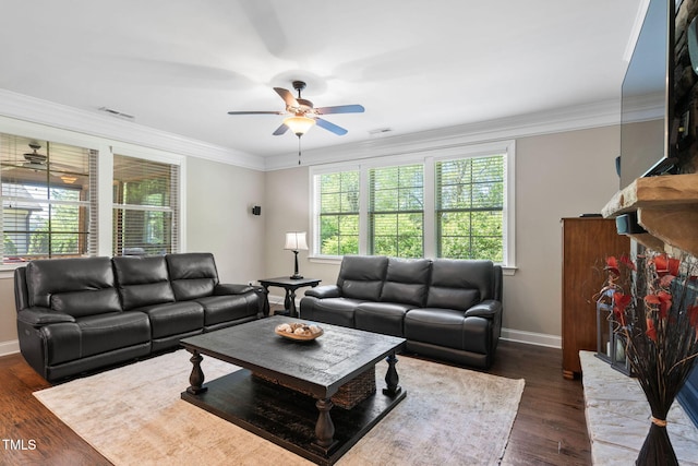 living room with ceiling fan, plenty of natural light, visible vents, and baseboards