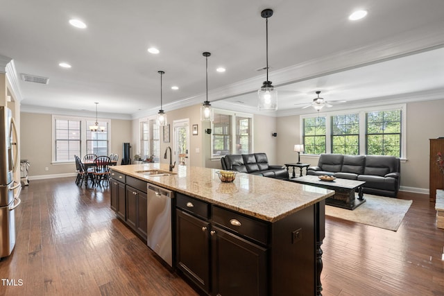 kitchen with baseboards, stainless steel appliances, plenty of natural light, and a sink