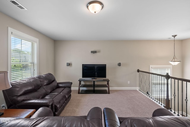 carpeted living room featuring visible vents and baseboards