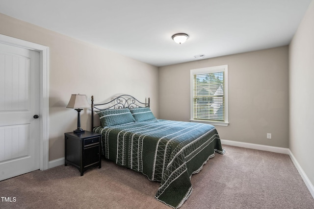 carpeted bedroom featuring baseboards