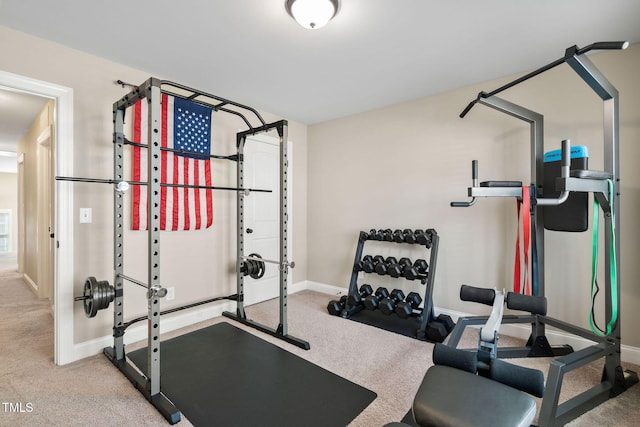 workout area featuring carpet flooring and baseboards