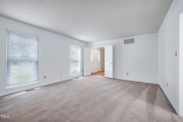 3900 Inkberry Ct, Apex, NC 27539 - empty room with light colored carpet, ornamental molding, and a textured ceiling