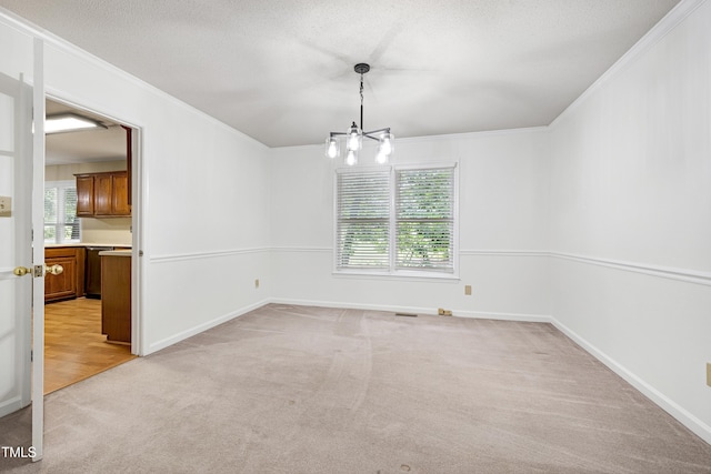 3900 Inkberry Ct, Apex, NC 27539 - unfurnished room with light colored carpet, ornamental molding, a chandelier, and a textured ceiling
