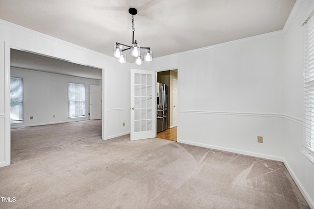 3900 Inkberry Ct, Apex, NC 27539 - carpeted spare room featuring a chandelier, french doors, and crown molding