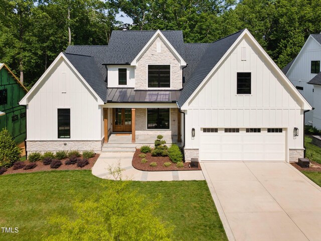 3832 Noremac Dr, Raleigh, NC 27612 - modern inspired farmhouse with stone siding, board and batten siding, and a porch