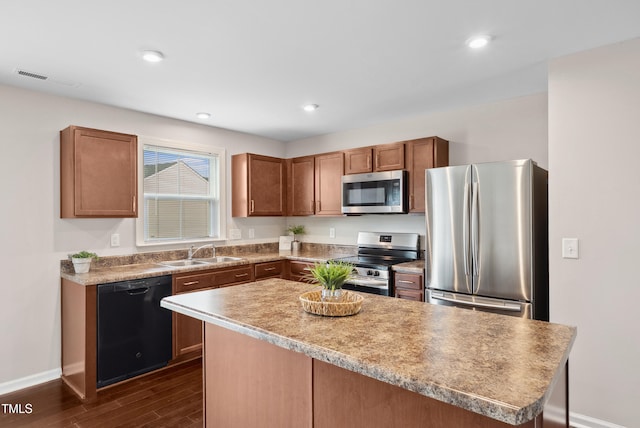 1004 Summer Mist Ln, Durham, NC 27704 - kitchen featuring appliances with stainless steel finishes, dark wood-style floors, a center island, recessed lighting, and light countertops