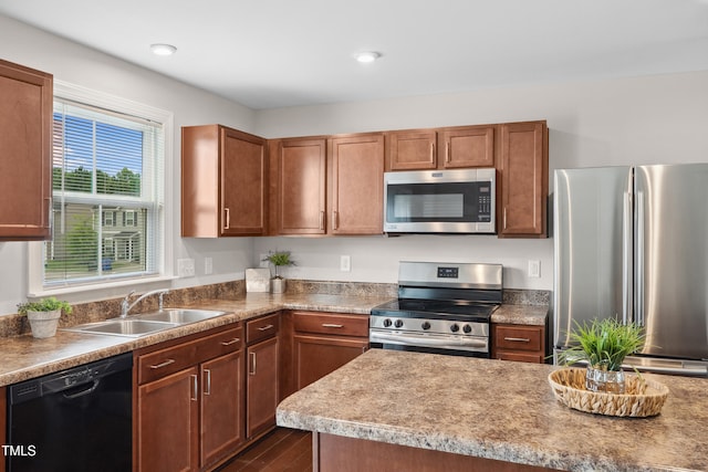 1004 Summer Mist Ln, Durham, NC 27704 - kitchen with appliances with stainless steel finishes, dark wood-type flooring, recessed lighting, and brown cabinetry
