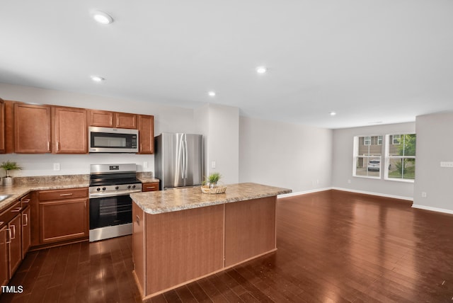 1004 Summer Mist Ln, Durham, NC 27704 - kitchen with appliances with stainless steel finishes, a center island, dark wood finished floors, light countertops, and recessed lighting