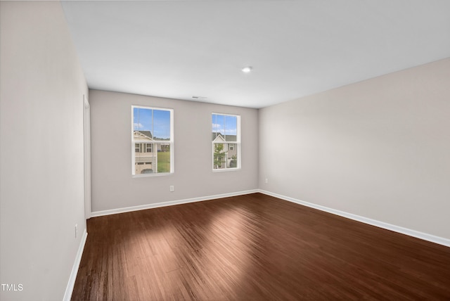 1004 Summer Mist Ln, Durham, NC 27704 - spare room featuring dark wood-type flooring and baseboards