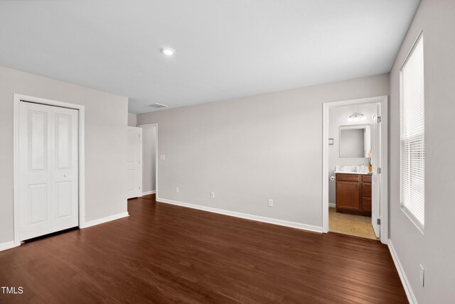 1004 Summer Mist Ln, Durham, NC 27704 - unfurnished bedroom featuring dark wood-style flooring, a closet, and ensuite bathroom