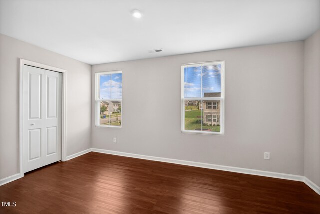 1004 Summer Mist Ln, Durham, NC 27704 - unfurnished bedroom featuring dark wood finished floors and a closet