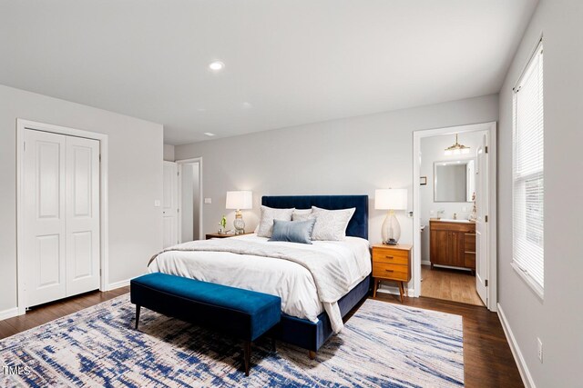 1004 Summer Mist Ln, Durham, NC 27704 - bedroom featuring wood finished floors, multiple windows, a closet, and ensuite bath