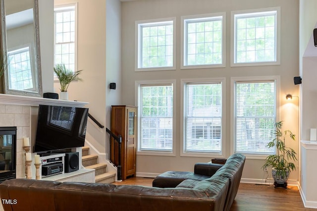 living room featuring baseboards, wood finished floors, and a wealth of natural light