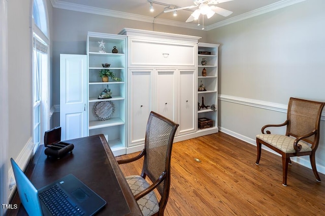 office area featuring baseboards, ornamental molding, a ceiling fan, and wood finished floors
