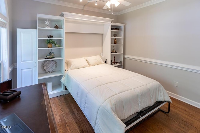 bedroom featuring baseboards, ornamental molding, and wood finished floors