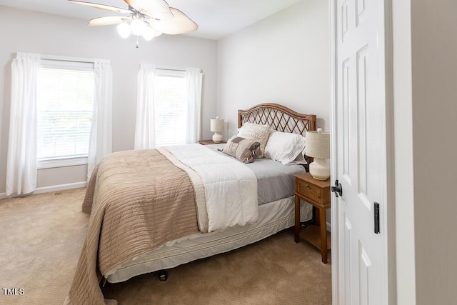 bedroom with carpet floors, baseboards, and ceiling fan