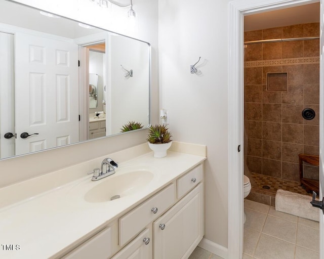 bathroom featuring vanity, toilet, tile patterned flooring, and a stall shower