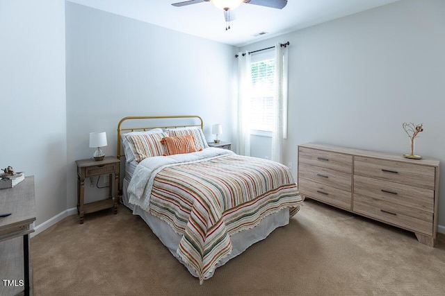 bedroom with visible vents, a ceiling fan, baseboards, and light carpet