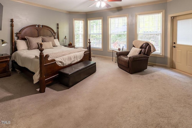 carpeted bedroom featuring baseboards, ornamental molding, and ceiling fan