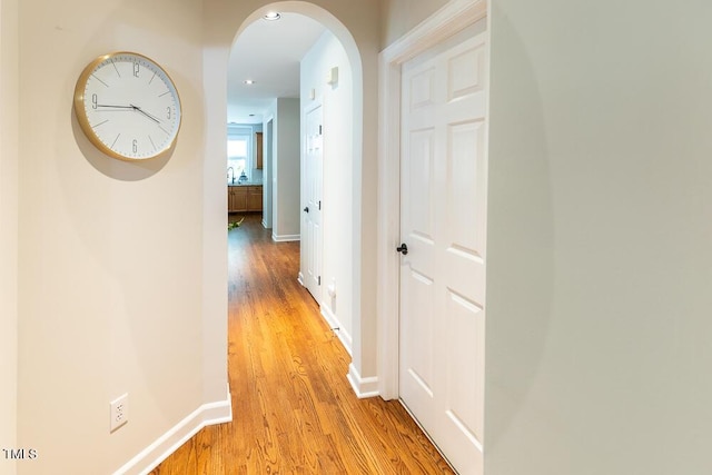 5129 Bartons Enclave Ln, Raleigh, NC 27613 - corridor featuring light wood-style floors, arched walkways, baseboards, and recessed lighting