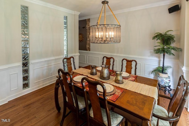 5129 Bartons Enclave Ln, Raleigh, NC 27613 - dining space with wood finished floors, a chandelier, ornamental molding, a wainscoted wall, and a decorative wall
