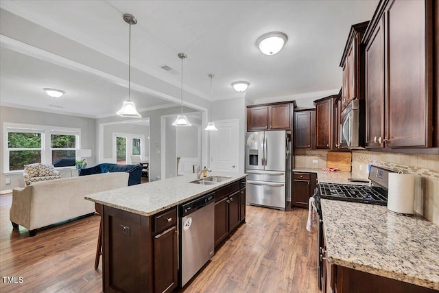 108 Princess Pl, Morrisville, NC 27560 - kitchen with a sink, open floor plan, appliances with stainless steel finishes, and light wood finished floors