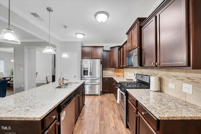 108 Princess Pl, Morrisville, NC 27560 - kitchen featuring light wood-style flooring, backsplash, dark brown cabinets, stainless steel appliances, and a sink