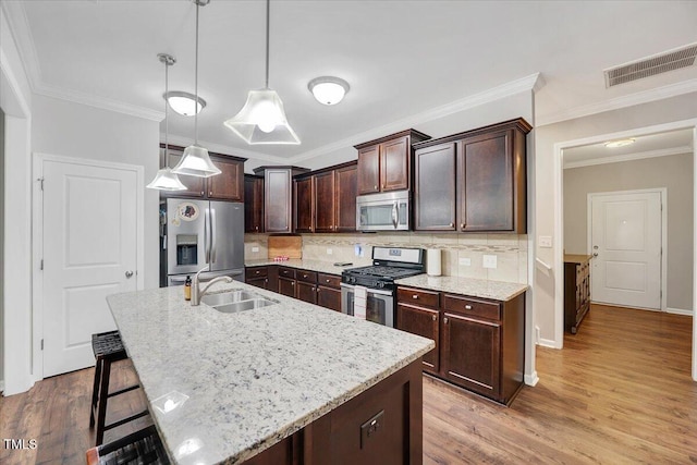 108 Princess Pl, Morrisville, NC 27560 - kitchen featuring dark brown cabinetry, backsplash, visible vents, stainless steel appliances, and a sink