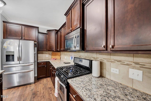 108 Princess Pl, Morrisville, NC 27560 - kitchen with tasteful backsplash, ornamental molding, light stone counters, appliances with stainless steel finishes, and light wood finished floors