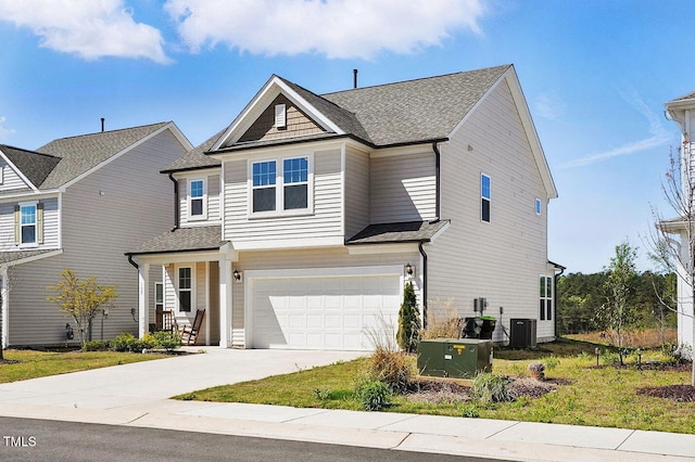 view of front facade with an attached garage, roof with shingles, driveway, and central air condition unit