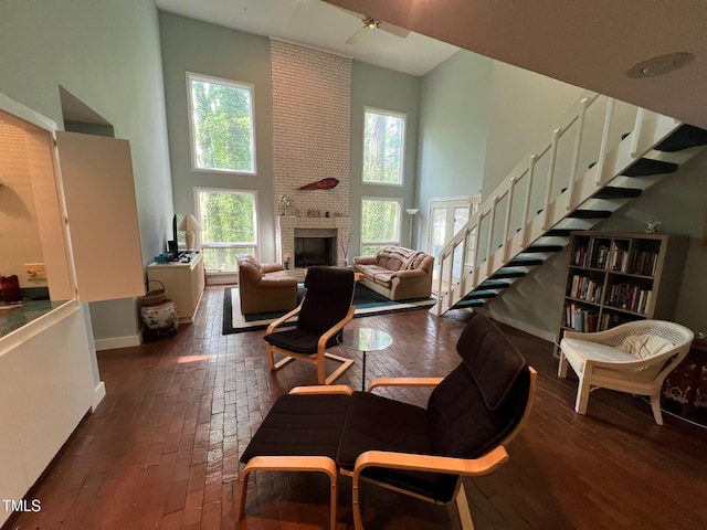 106 Orchard Rd, Henderson, NC 27536 - living area featuring a towering ceiling, a fireplace, baseboards, and stairway