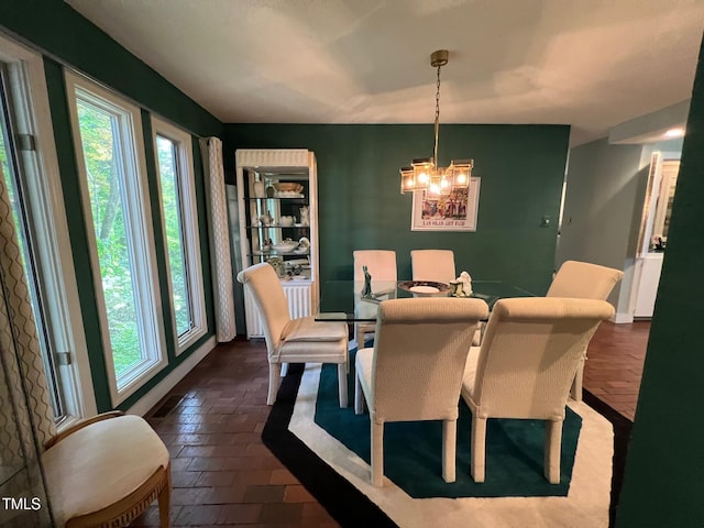 106 Orchard Rd, Henderson, NC 27536 - dining room featuring a chandelier and brick floors