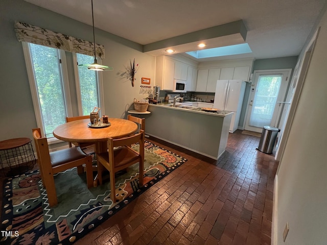 106 Orchard Rd, Henderson, NC 27536 - dining area with recessed lighting, a skylight, and brick floors