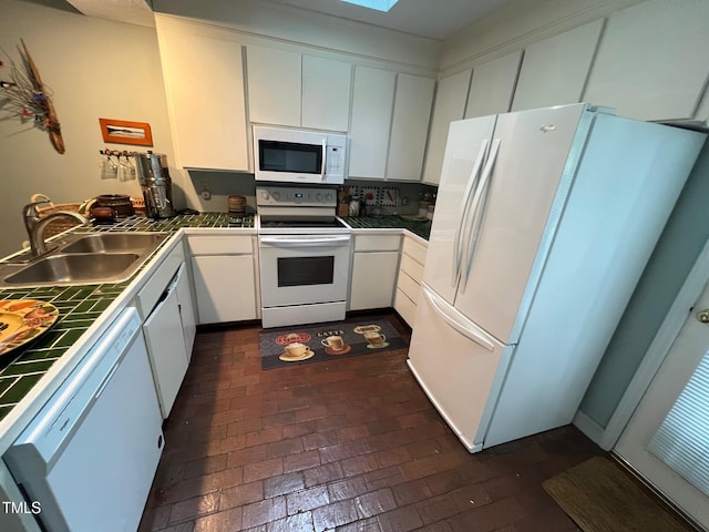 106 Orchard Rd, Henderson, NC 27536 - kitchen featuring white appliances, a sink, tile counters, and white cabinetry