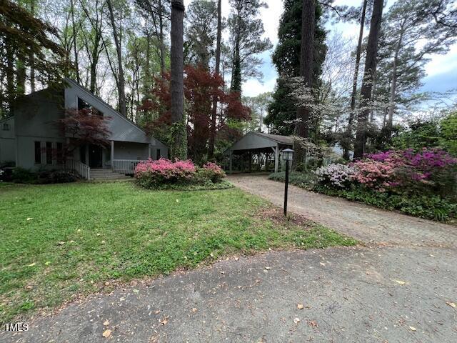 106 Orchard Rd, Henderson, NC 27536 - view of grassy yard with asphalt driveway and a porch