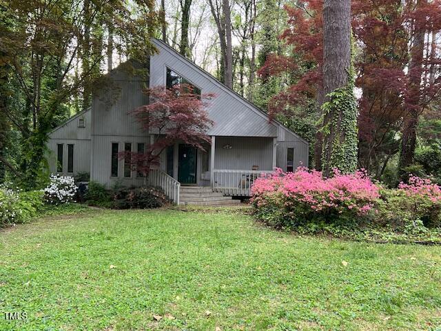 106 Orchard Rd, Henderson, NC 27536 - view of front facade featuring covered porch and a front lawn