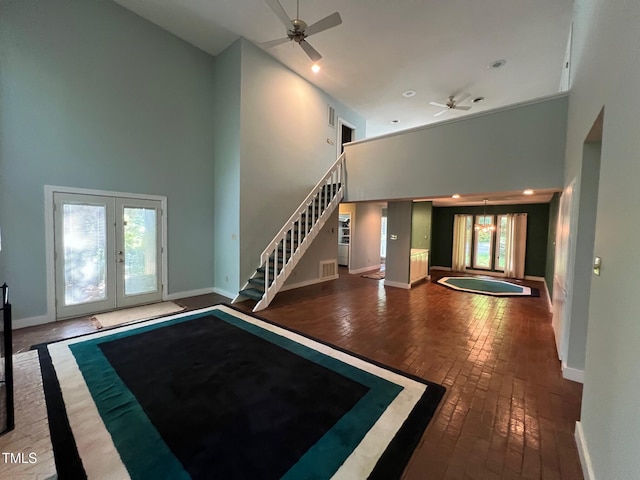 106 Orchard Rd, Henderson, NC 27536 - unfurnished living room featuring a high ceiling, ceiling fan, brick floors, french doors, and stairway