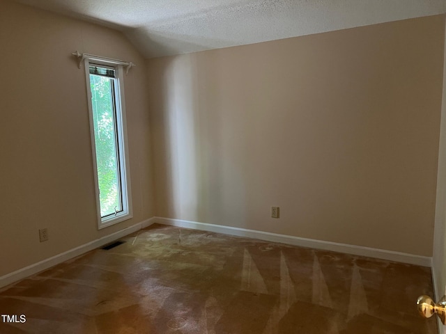 106 Orchard Rd, Henderson, NC 27536 - spare room with light carpet, a textured ceiling, baseboards, and vaulted ceiling