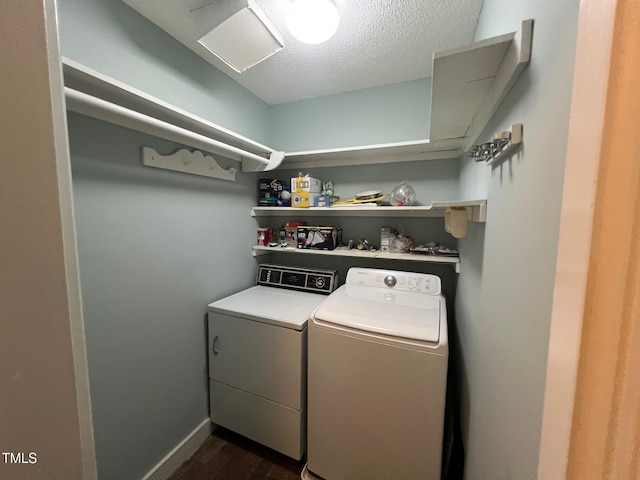 106 Orchard Rd, Henderson, NC 27536 - clothes washing area featuring washer and clothes dryer, dark wood finished floors, a textured ceiling, and baseboards