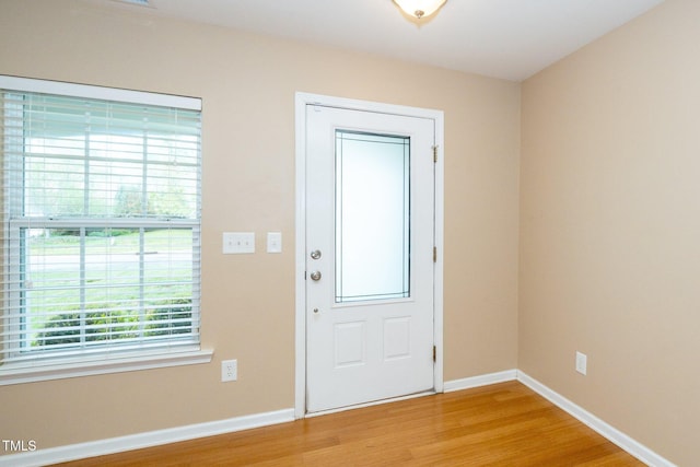 entryway featuring light wood finished floors and baseboards