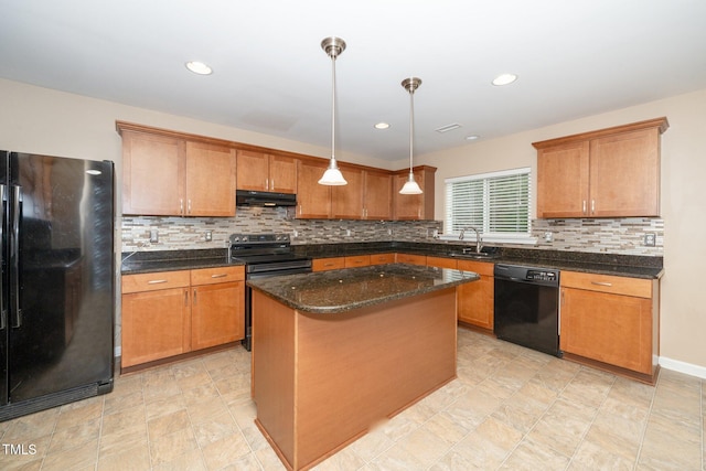 kitchen with brown cabinetry, under cabinet range hood, a sink, and black appliances