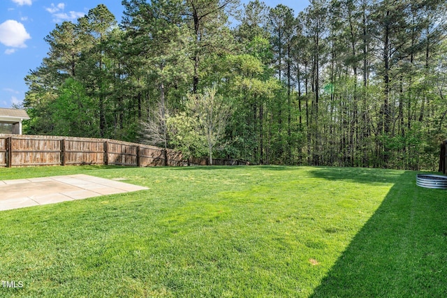 view of yard with fence and a patio