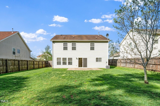 back of property with a patio area, a fenced backyard, central AC, and a lawn