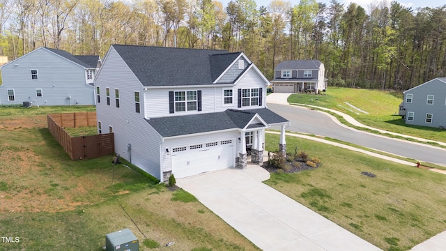 view of front of home with a front yard, a shingled roof, a garage, and concrete driveway