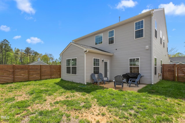 rear view of property with a patio, a yard, and a fenced backyard